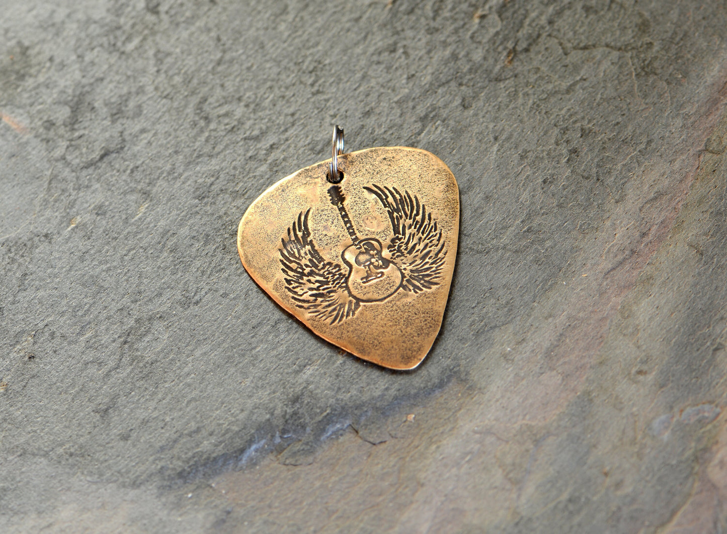 Winged guitar on bronze guitar pick necklace