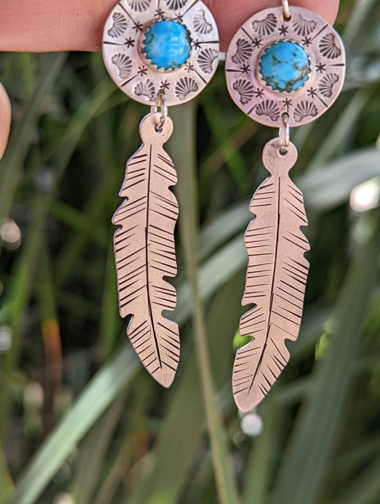 Sterling silver feather and shield earrings featuring 8mm Kingman mine turquoise and long dangle