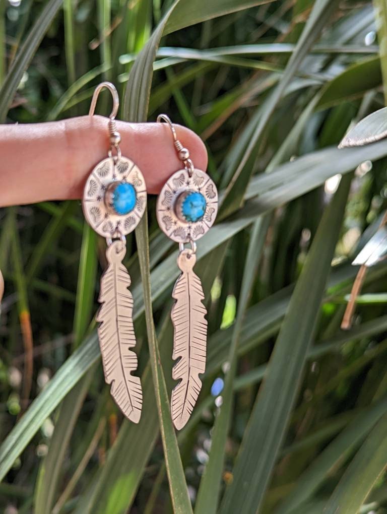 Sterling silver feather and shield earrings featuring 8mm Kingman mine turquoise and long dangle