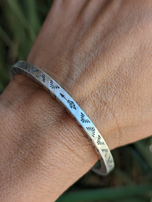 Square wire sterling silver cuff bracelet with hand stamped Thunderbird pattern on 3 sides