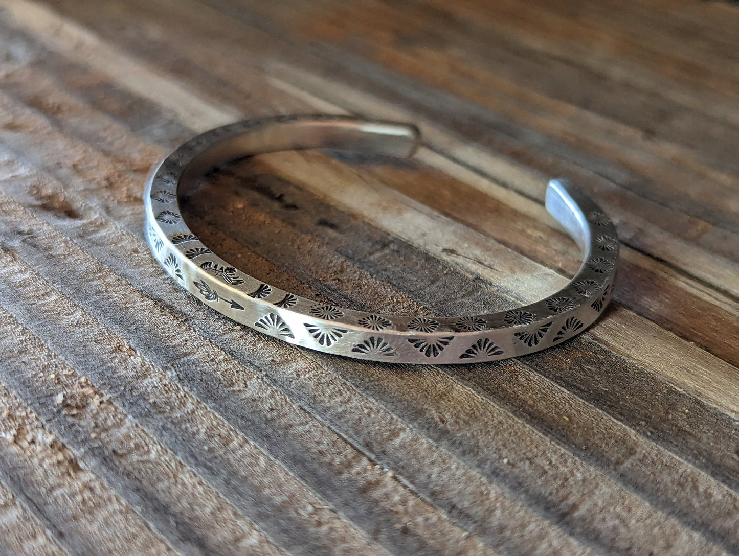 Square wire sterling silver cuff bracelet with hand stamped Thunderbird pattern on 3 sides