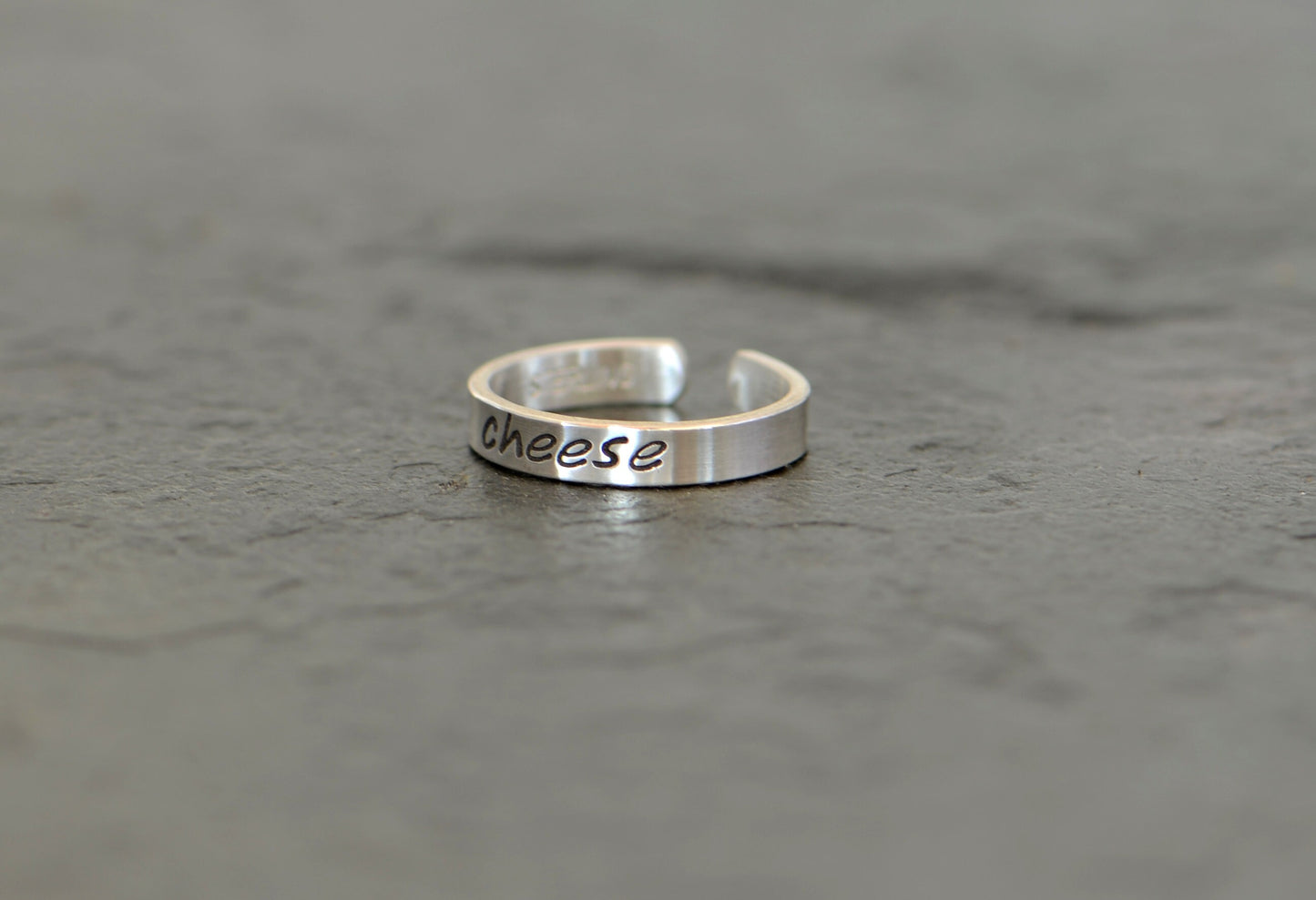 Sterling silver toe ring stamped with cheese in dainty style