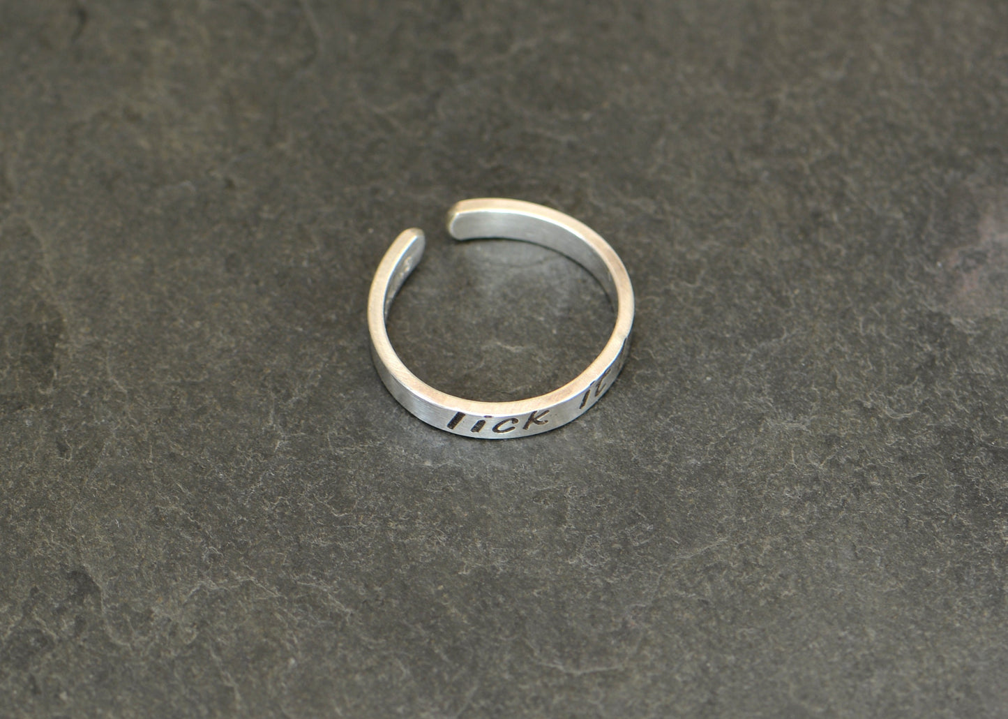 Sterling silver toe ring stamped with lick it