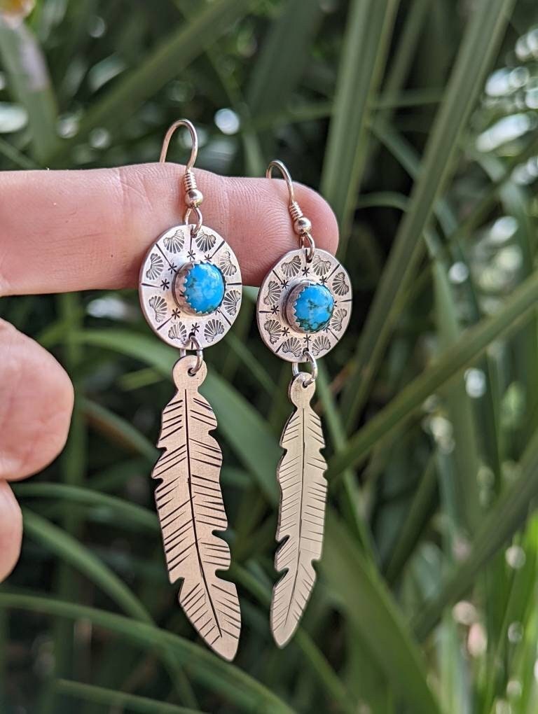 Sterling silver feather and shield earrings featuring 8mm Kingman mine turquoise and long dangle
