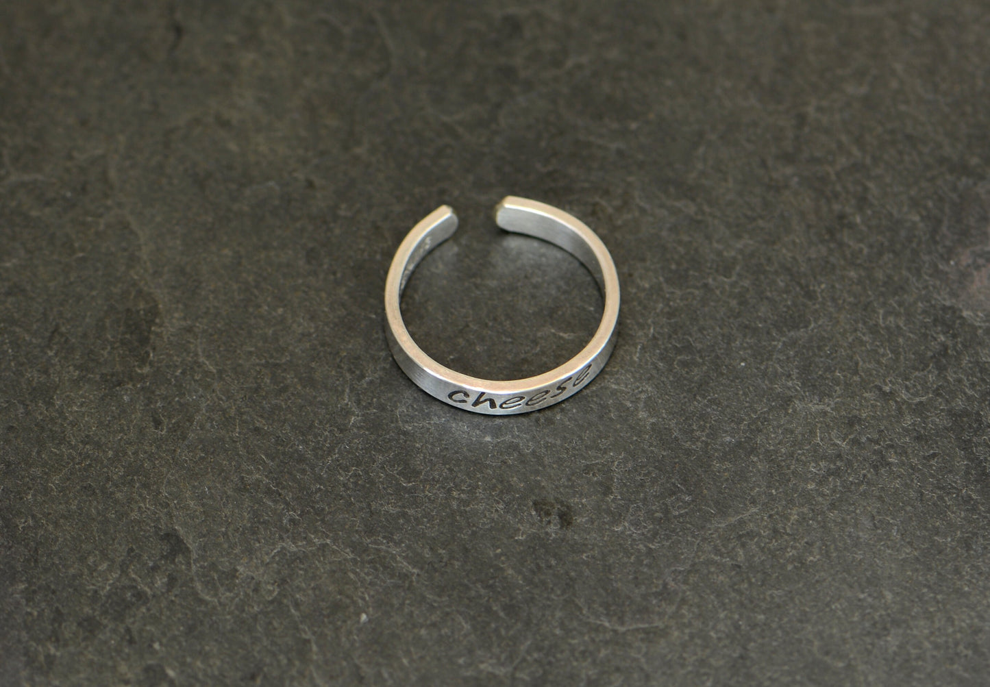 Sterling silver toe ring stamped with cheese in dainty style