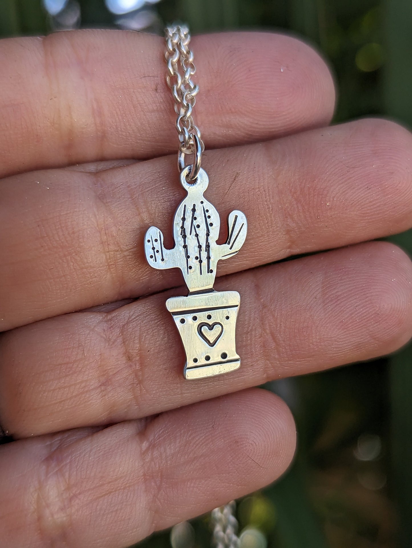 Silver cactus charm and small inspirational drawing