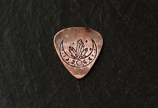 Copper guitar pick with crystal moon
