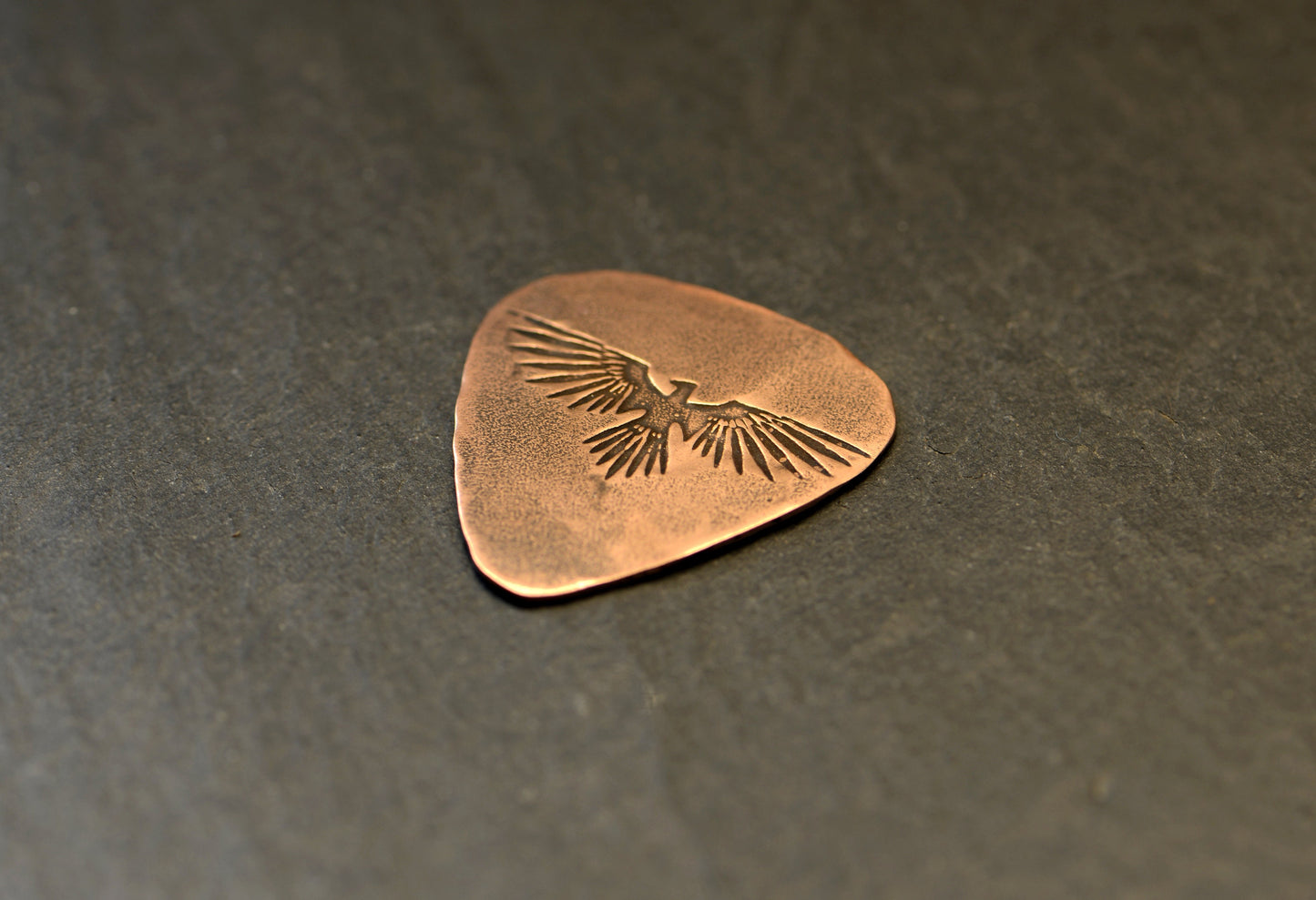 Copper guitar pick with Thunderbird