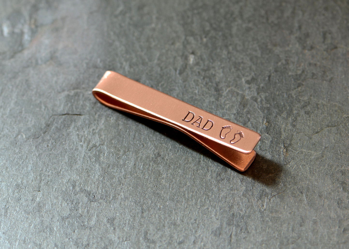 Copper tie clip for new dad stamped with DAD and baby feet