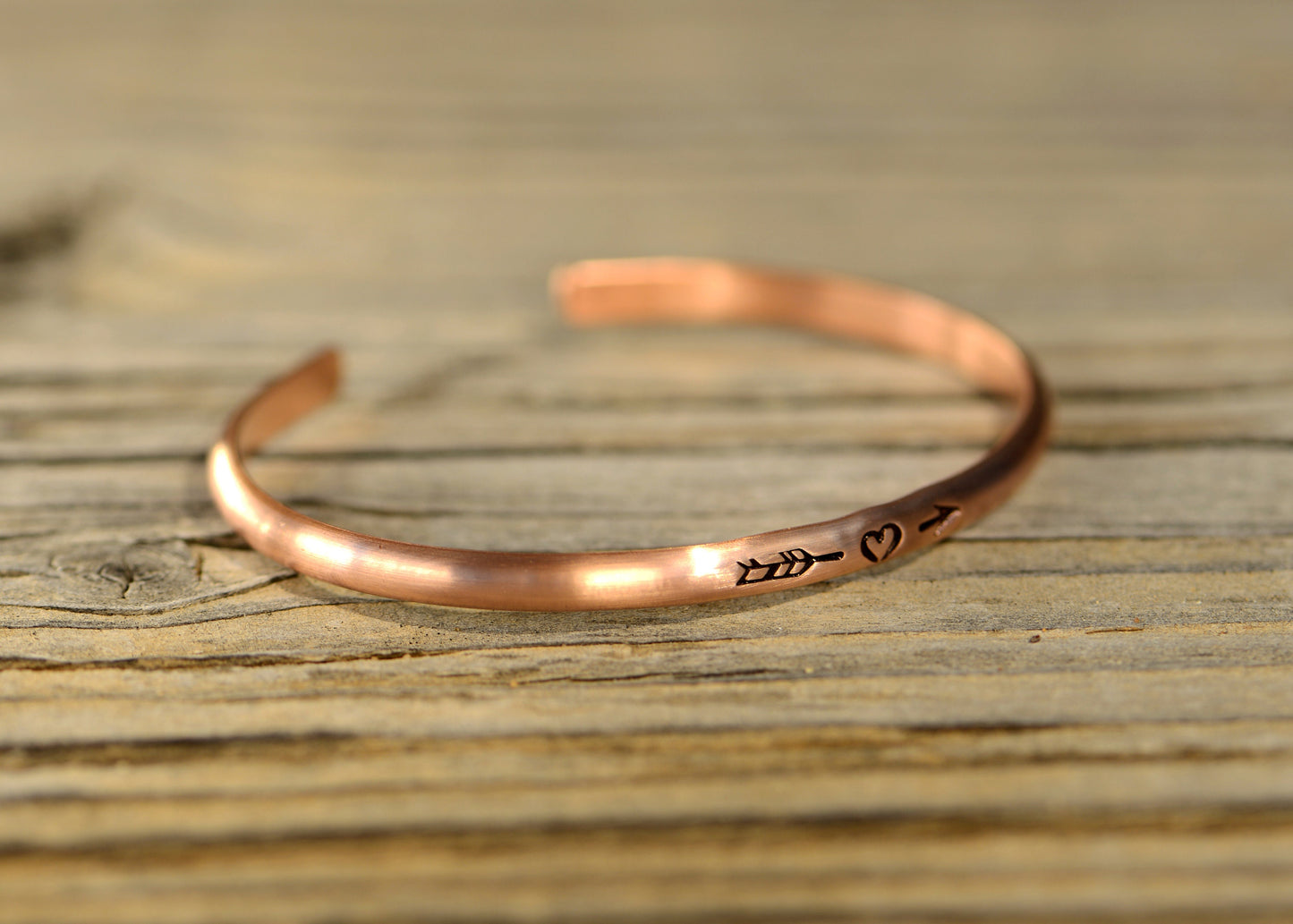 Copper bracelet with arrow and a heart in dainty styling for stacking