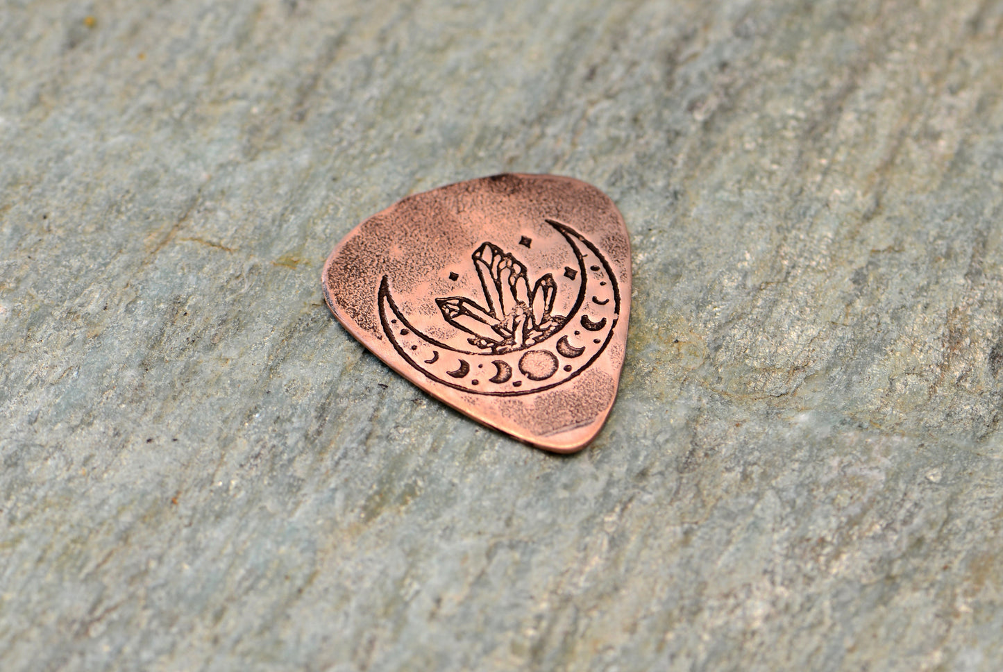 Copper guitar pick with crystal moon