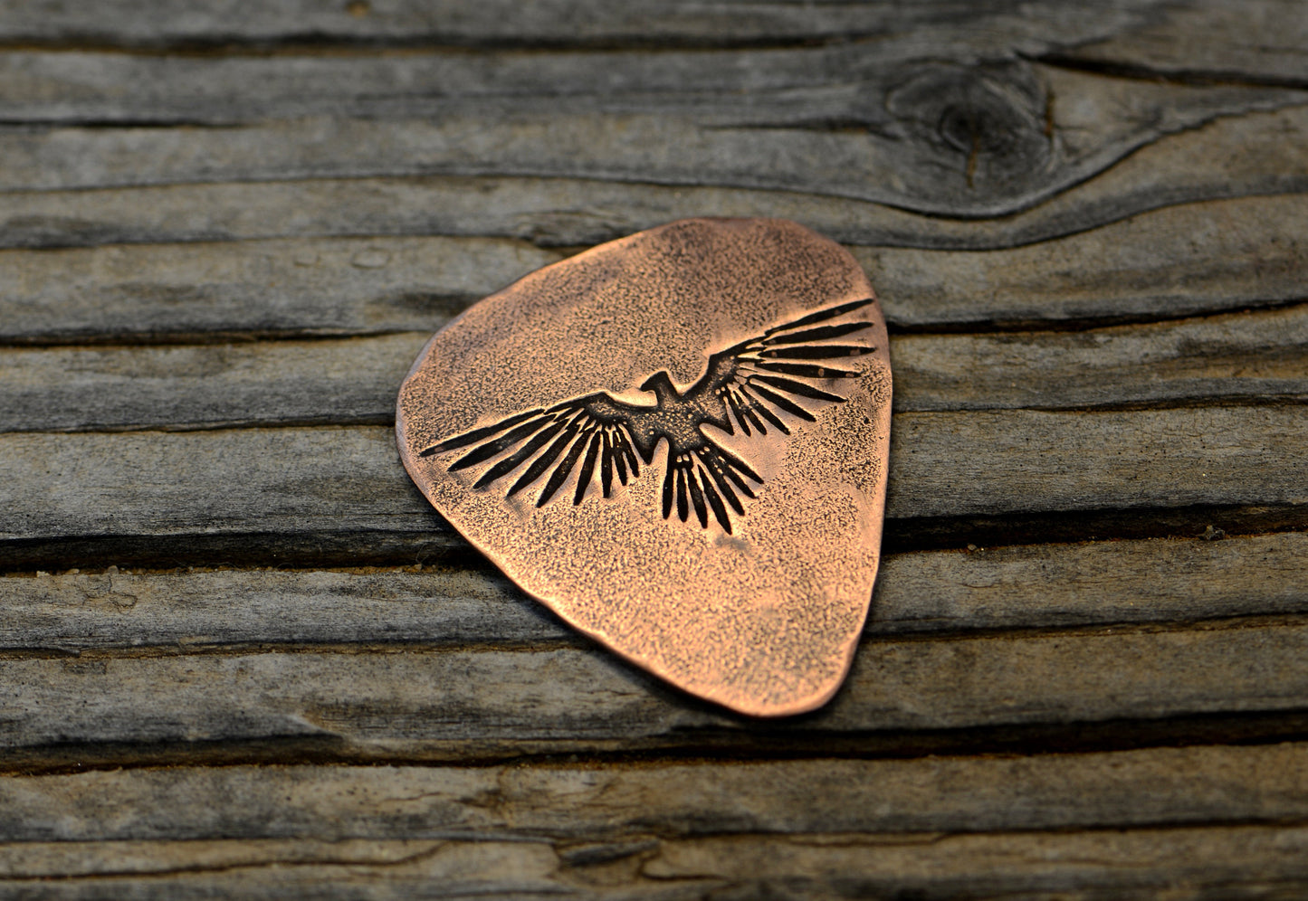 Copper guitar pick with Thunderbird