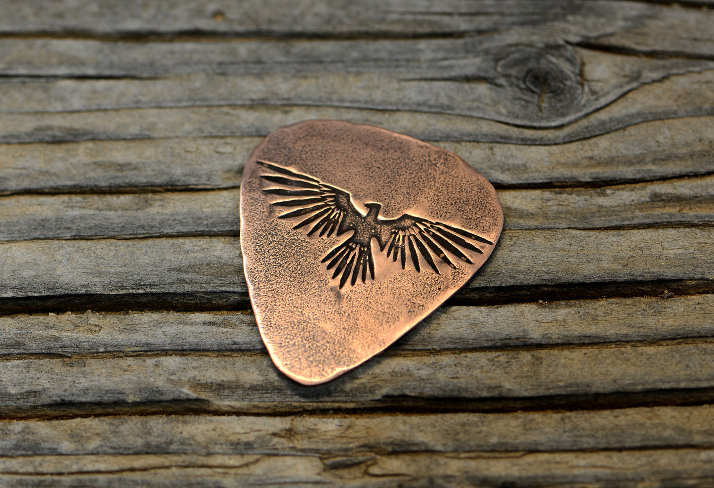 Copper guitar pick with Thunderbird