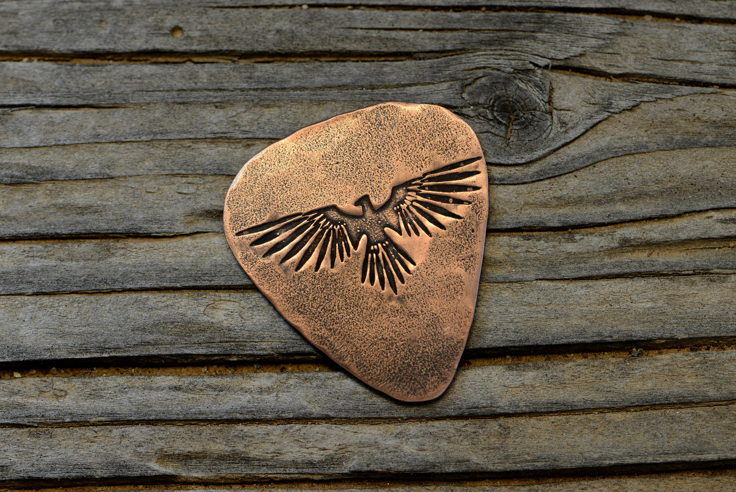 Copper guitar pick with Thunderbird