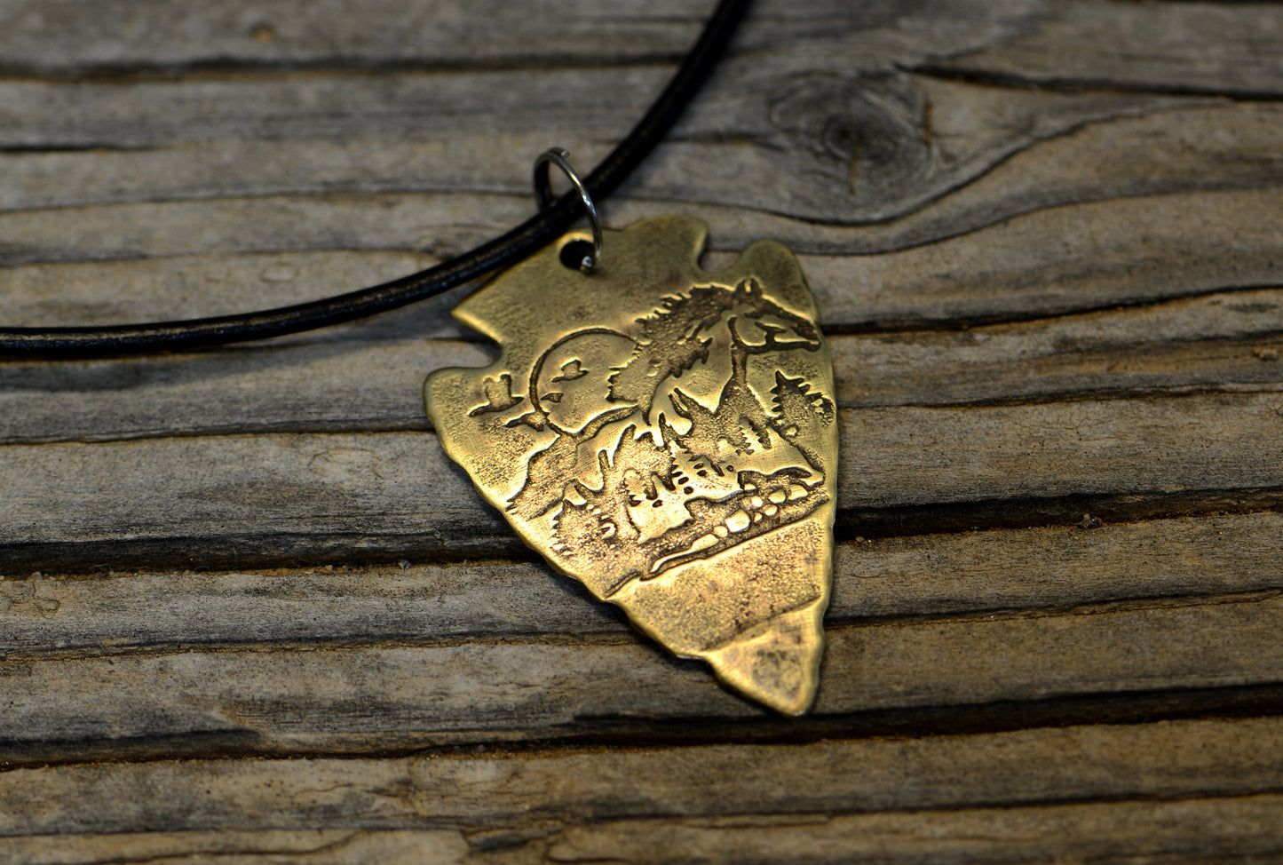 Bronze arrowhead necklace with horses and mountains