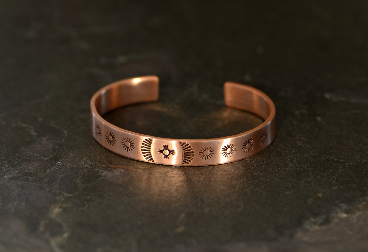 Cuff bracelet hand stamped with zia symbol and southwestern patterns in copper