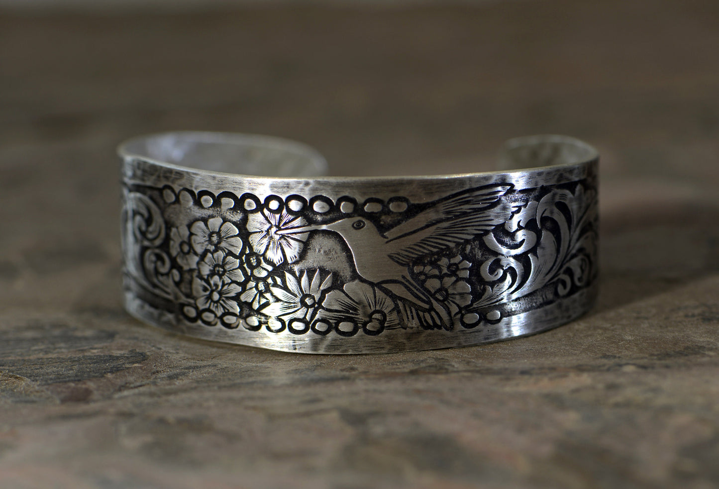 Hummingbird and flowers on a sterling silver cuff bracelet