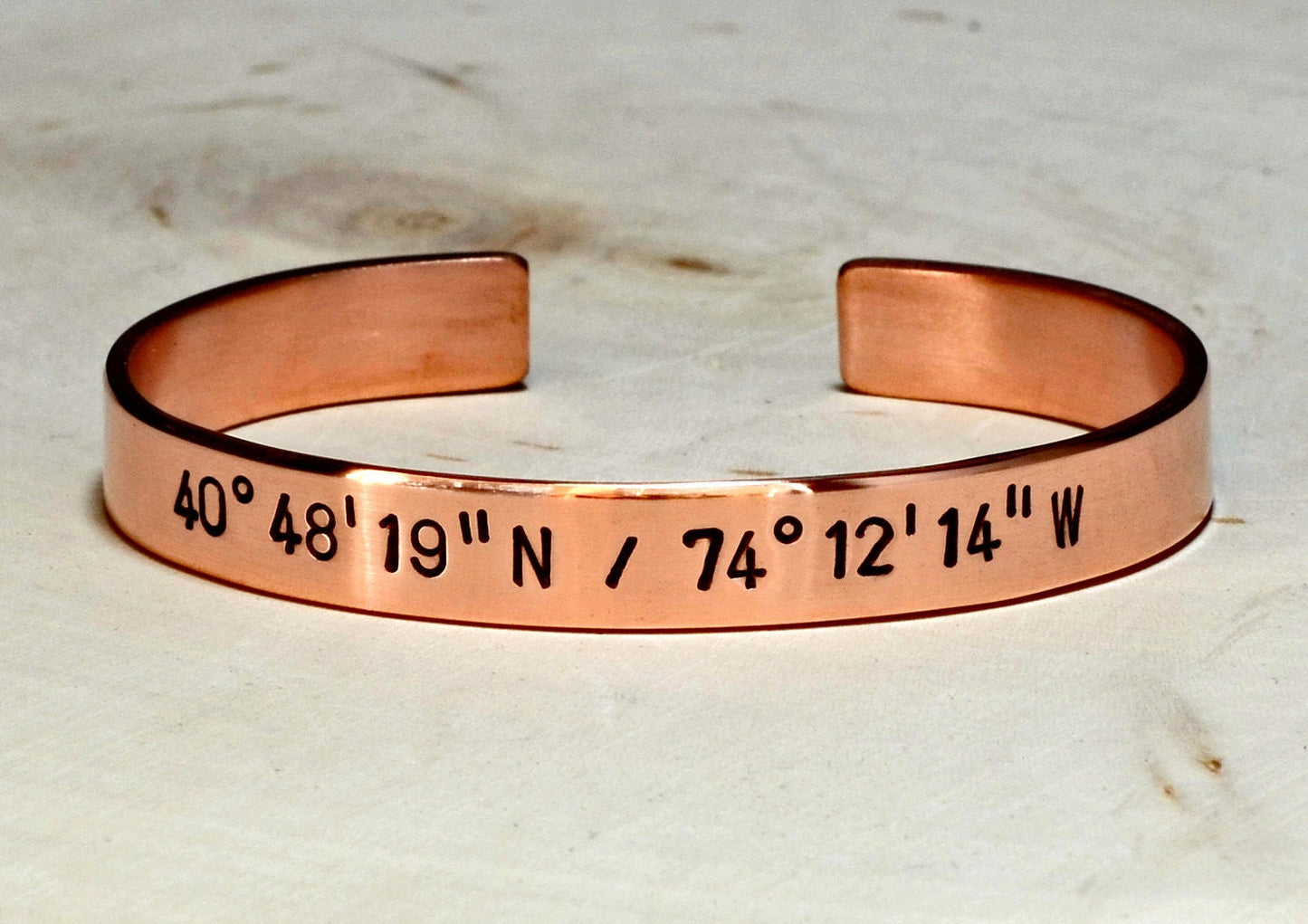 Personalized latitude longitude coordinates on copper cuff bracelet