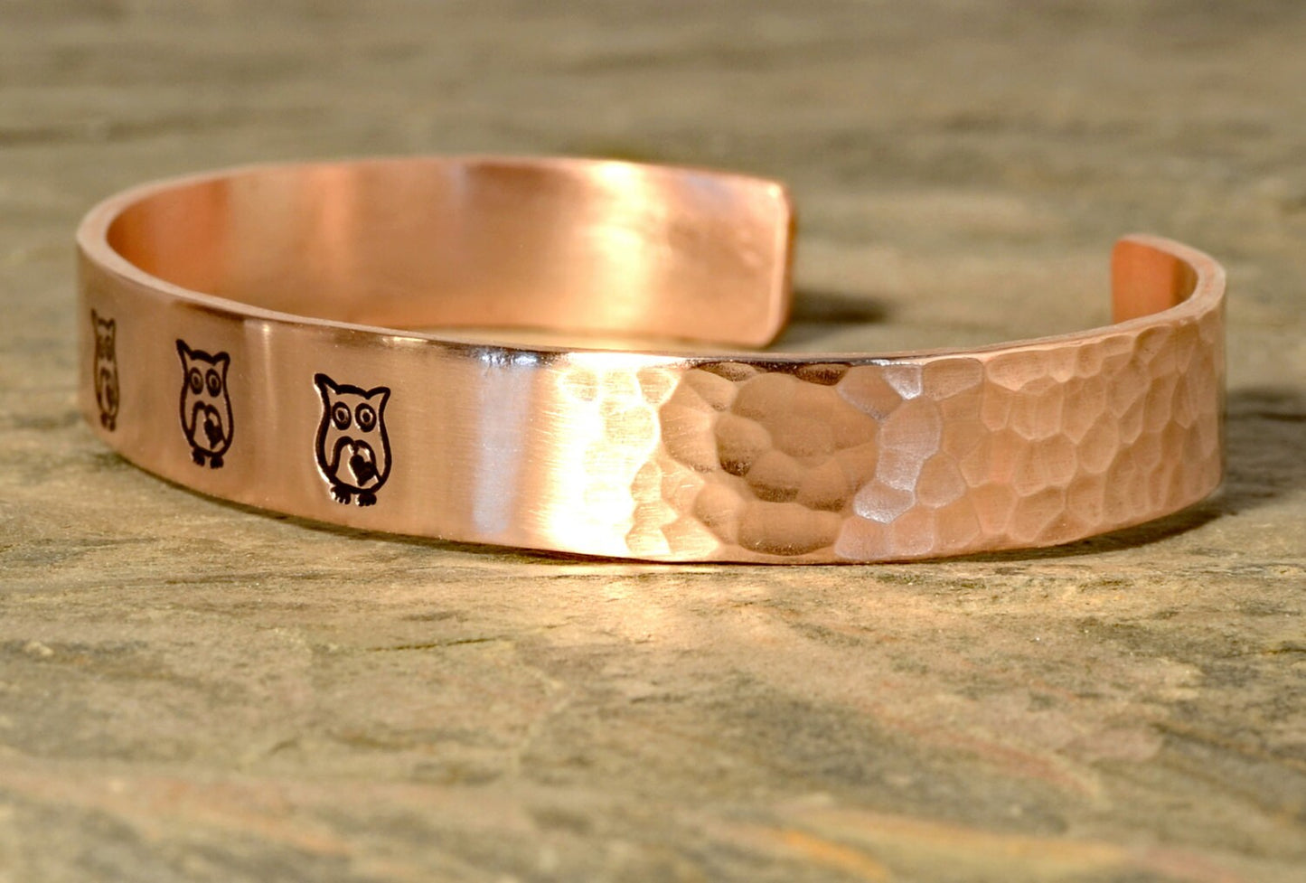 Copper cuff bracelet with hammered texture and owls