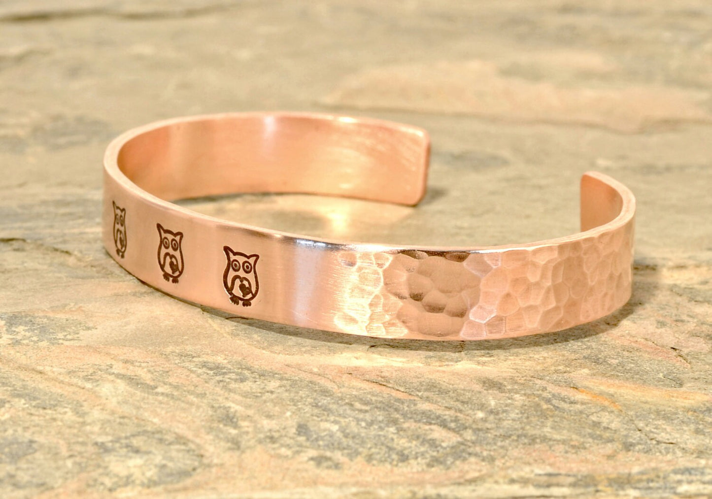 Copper cuff bracelet with hammered texture and owls