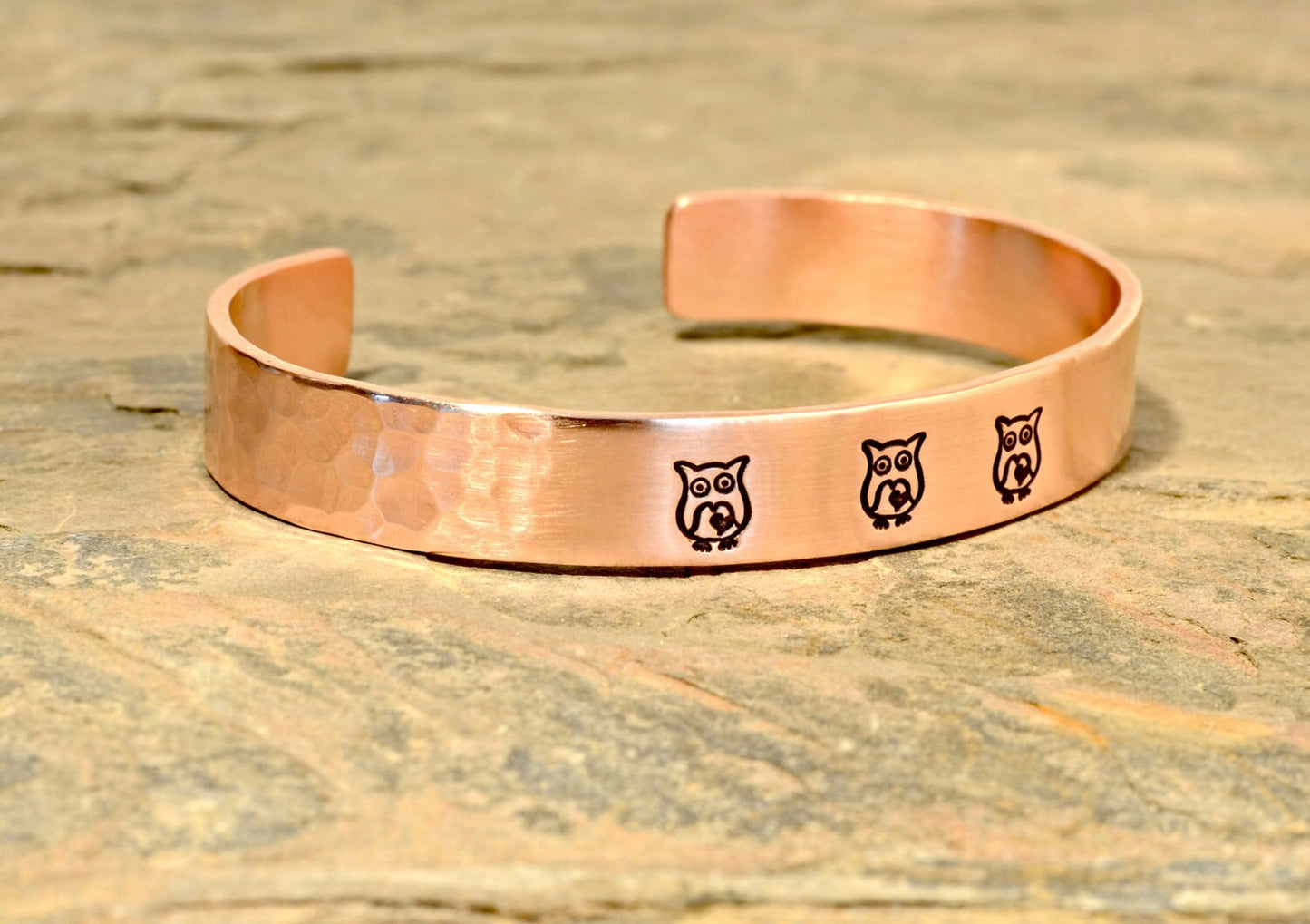 Copper cuff bracelet with hammered texture and owls