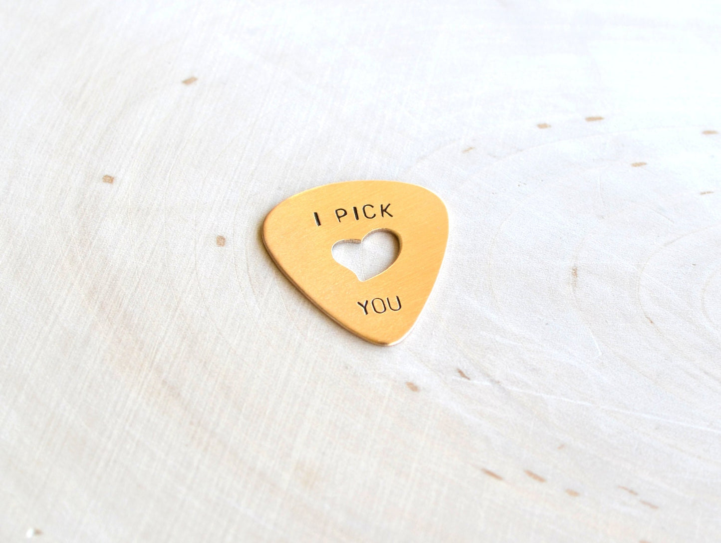 Heart in bronze guitar pick and I pick you