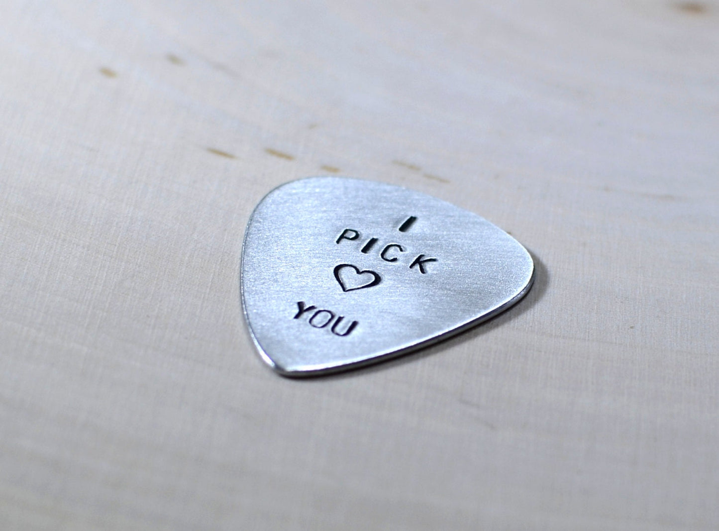 Aluminum I pick you guitar pick with a small heart design