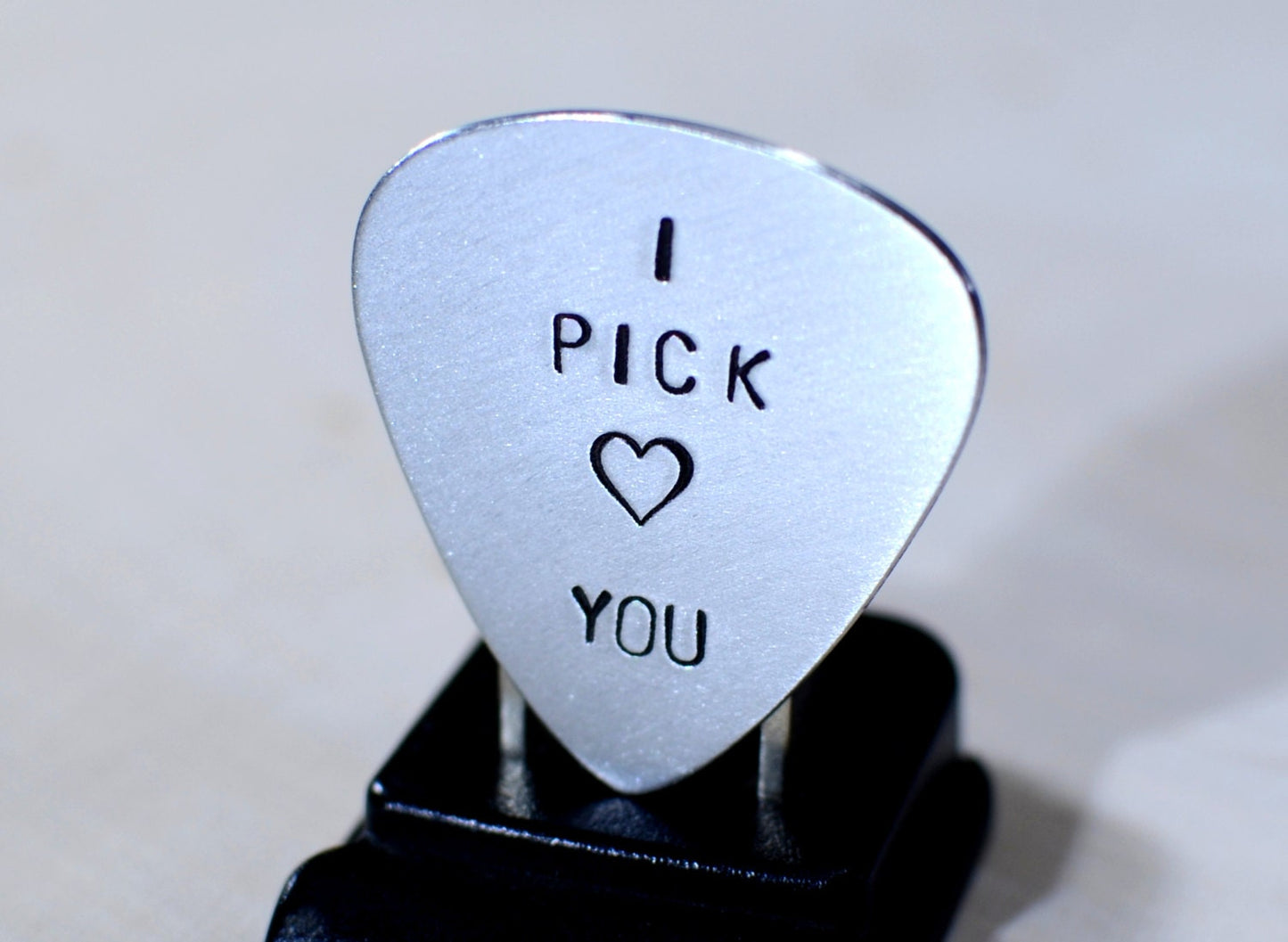 Aluminum I pick you guitar pick with a small heart design
