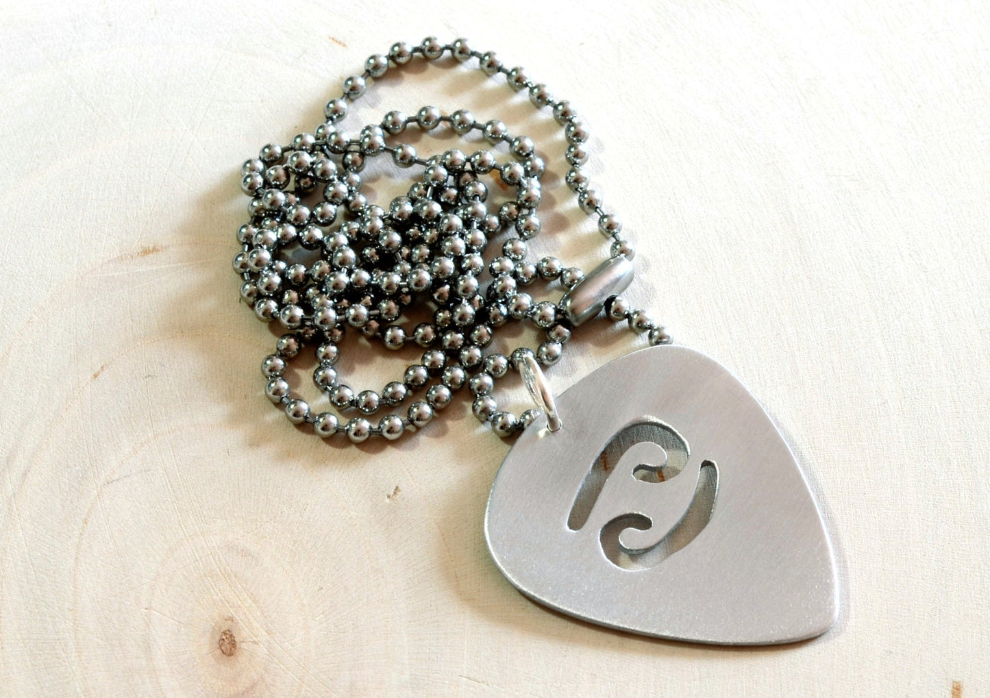 Zodiac sign guitar pick necklace with personalized astrology theme in various metals