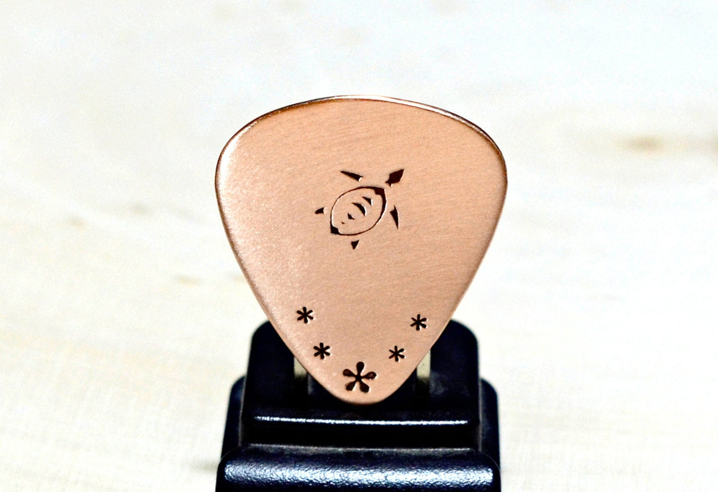 Copper guitar pick with sea turtle