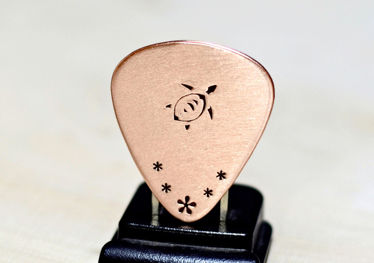 Copper guitar pick with sea turtle