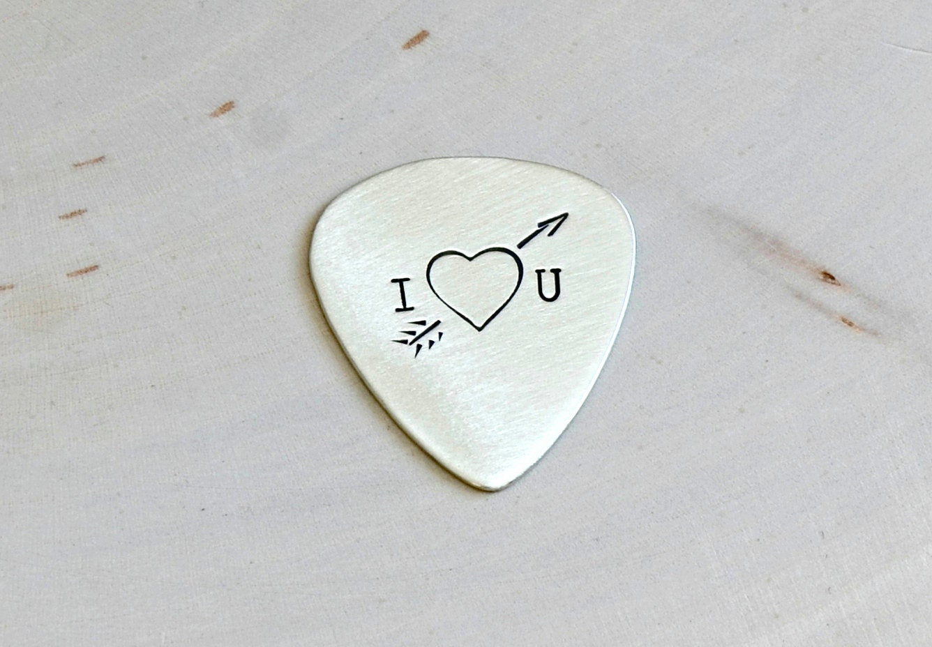 Heart and arrow theme on sterling silver guitar pick