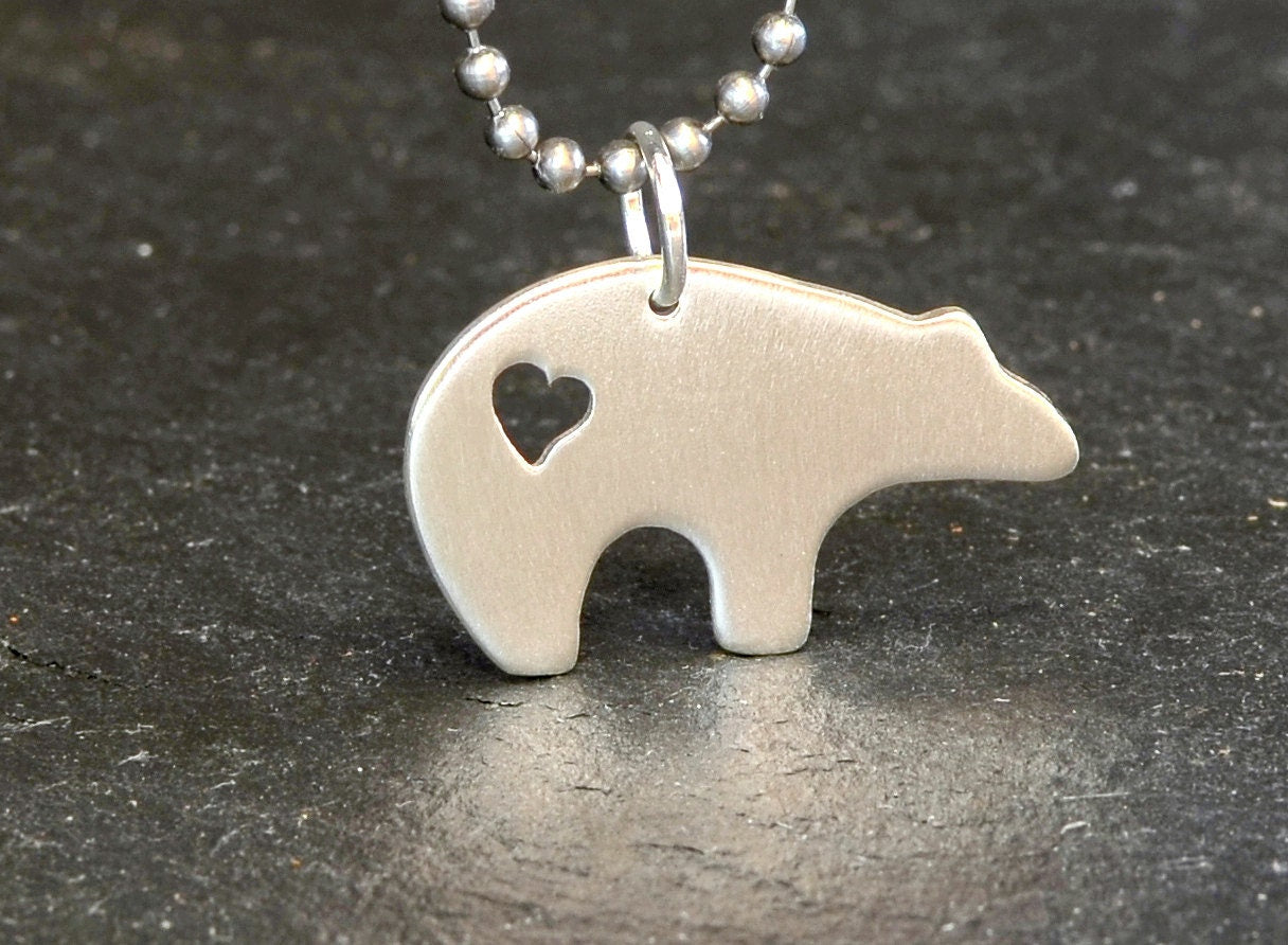 Sterling silver spirit bear necklace with cutout heart design