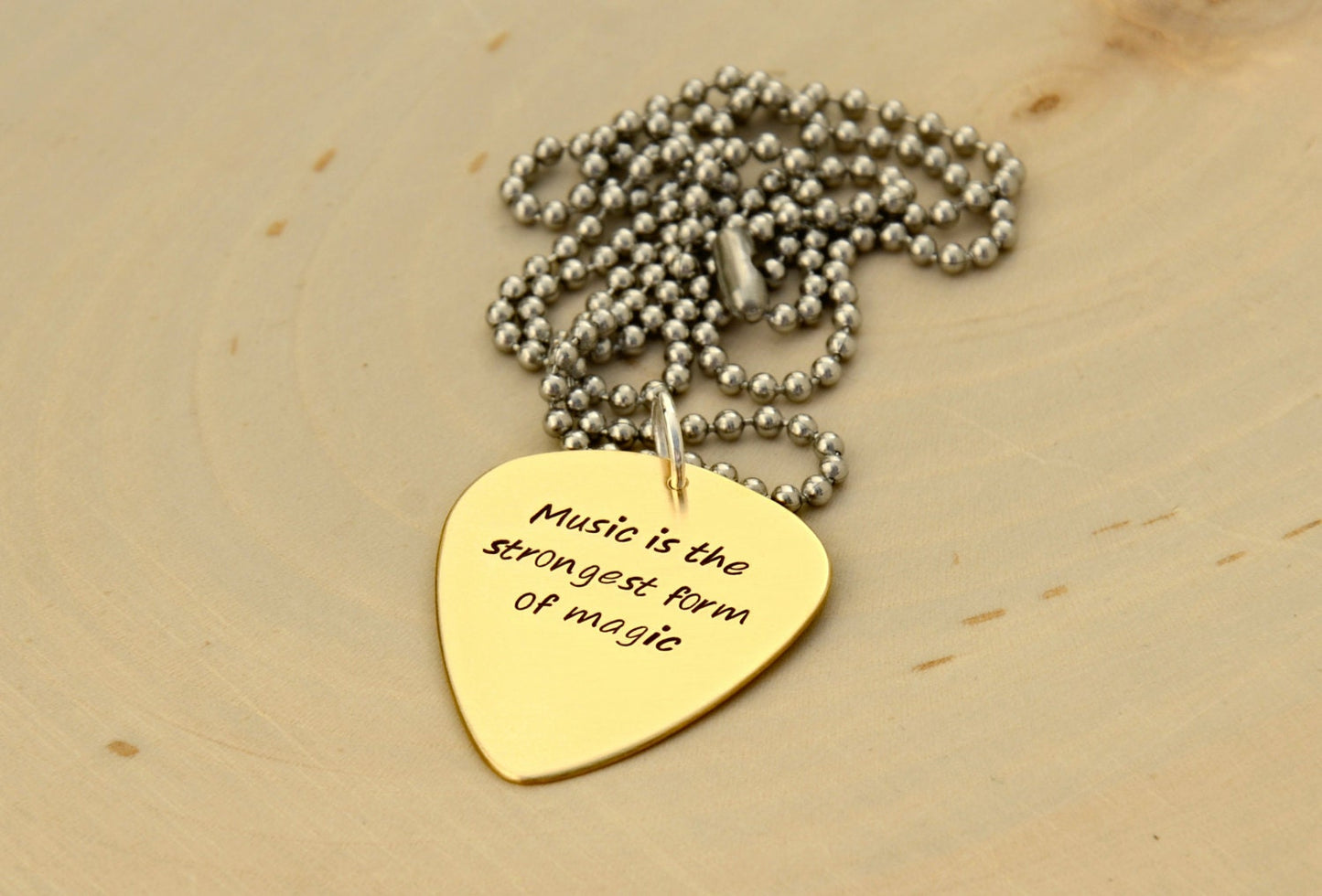 Bronze guitar pick necklace to engrave