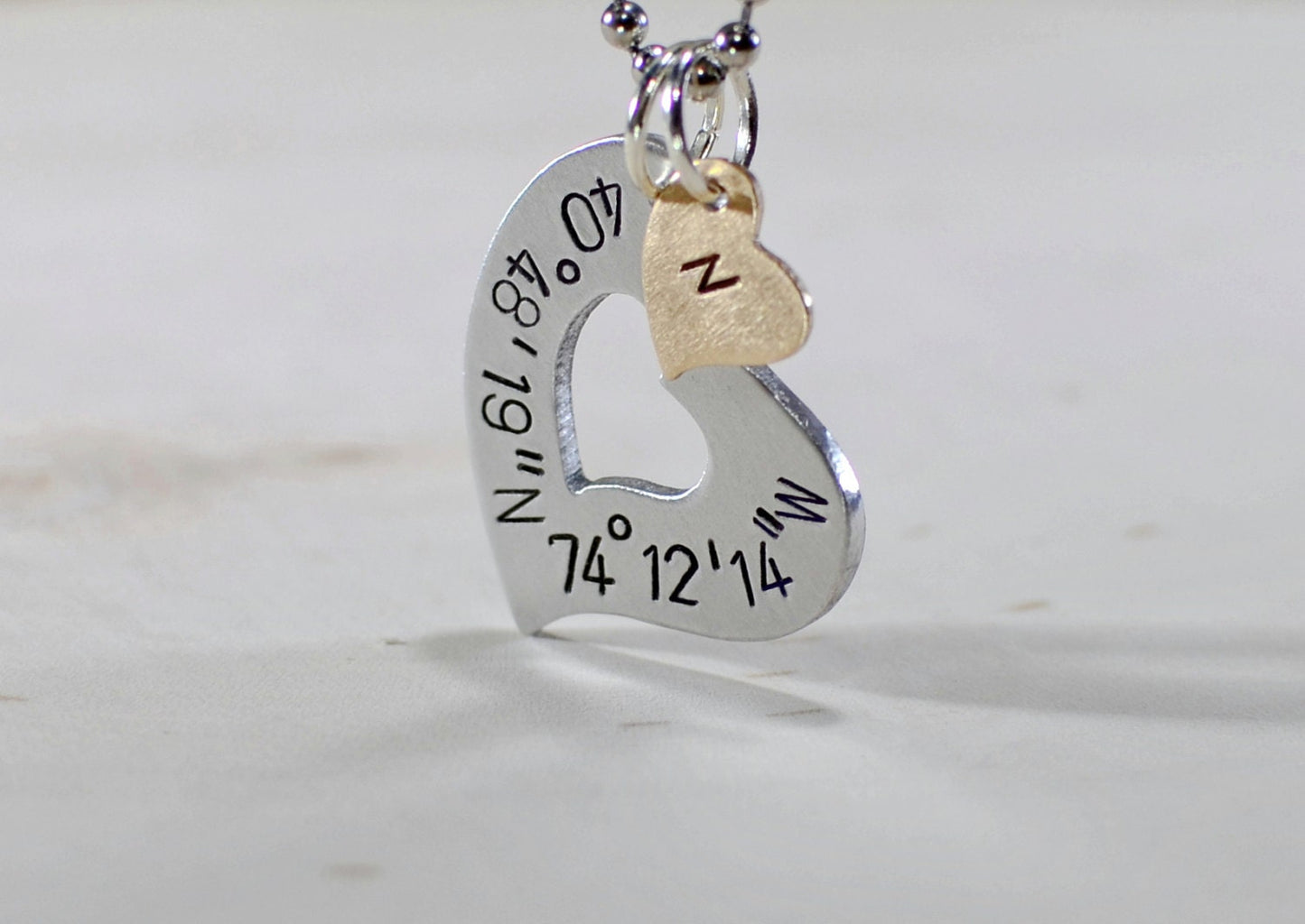 Sterling silver heart necklace with personalized latitude longitude coordinates with Bronze Heart Charm