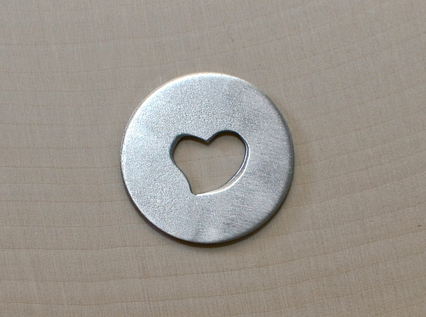 Golf ball marker with a heart cut out