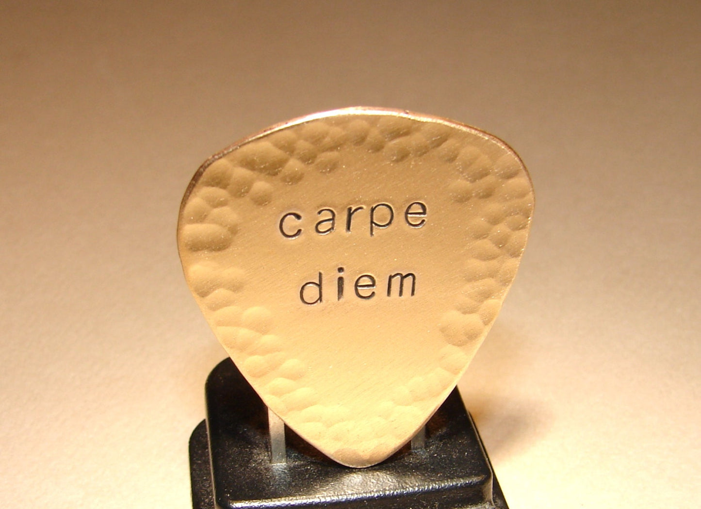 Carpe diem guitar pick with hammered edges in bronze