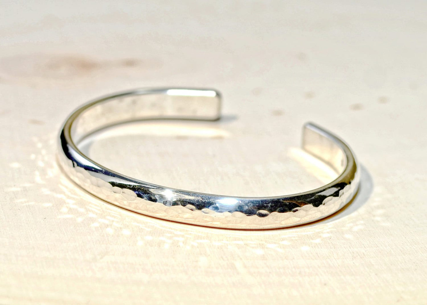 Sterling silver half round bracelet with hammered texture and mirror finish