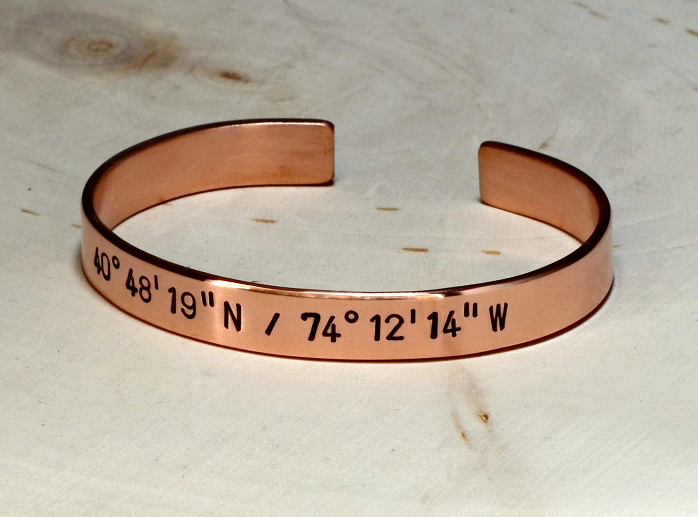 Personalized latitude longitude coordinates on copper cuff bracelet